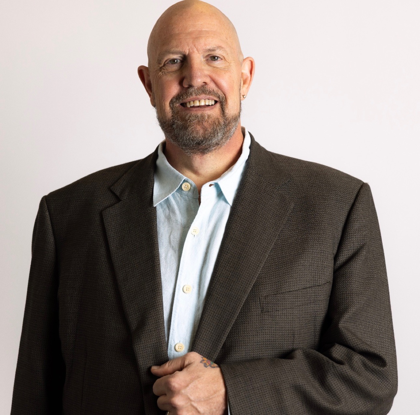Dr. Jeffrey Piccirillo, DO, smiling in a dark blazer and light blue shirt