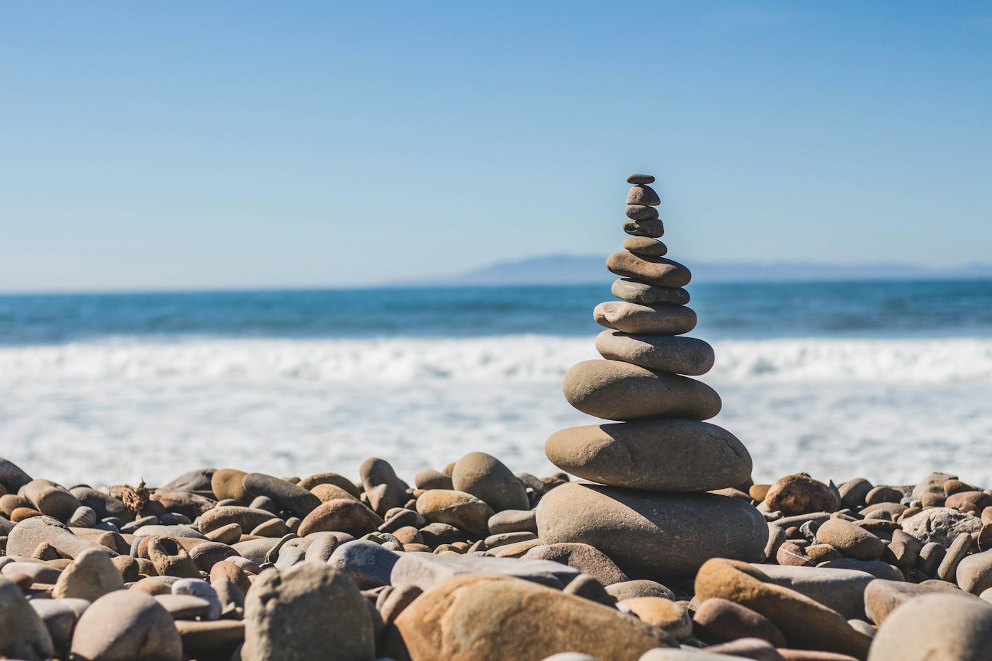 Balanced stacked stones by the sea