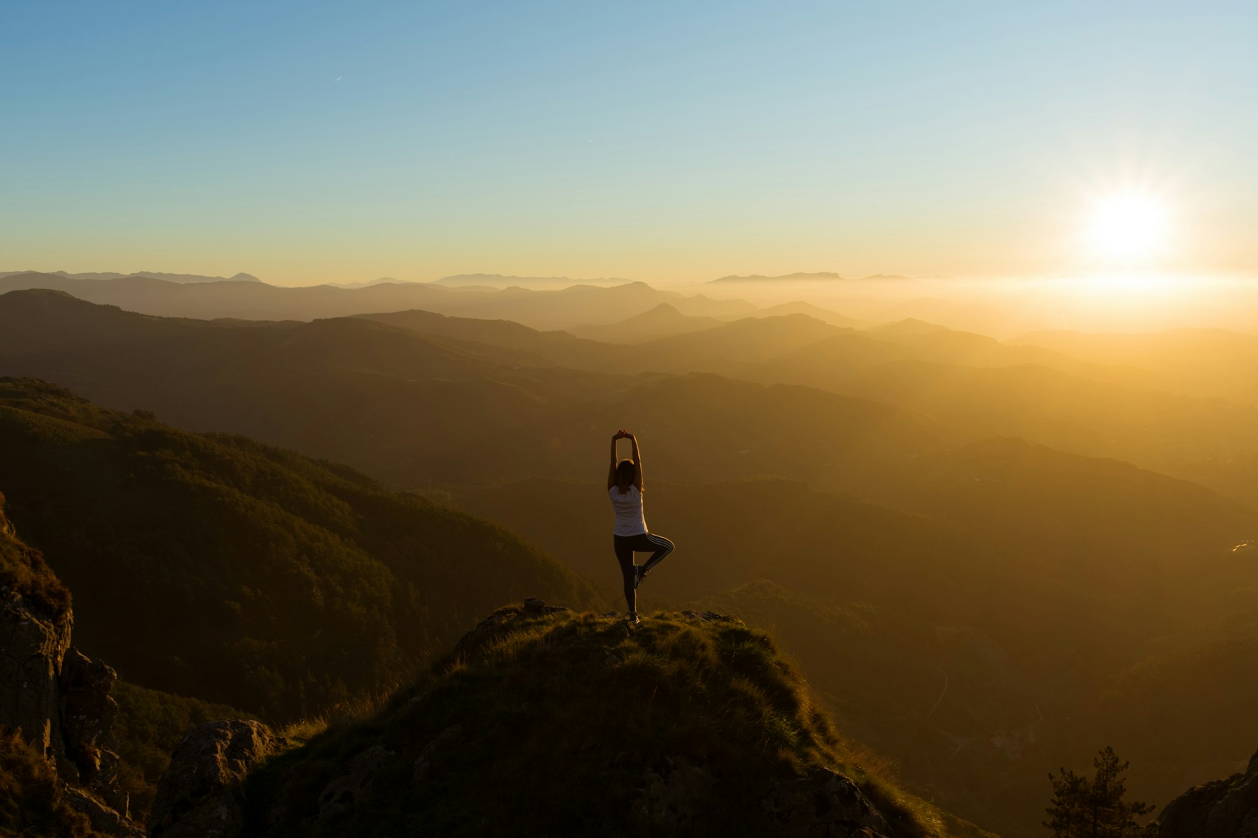 A person on a summit at sunrise